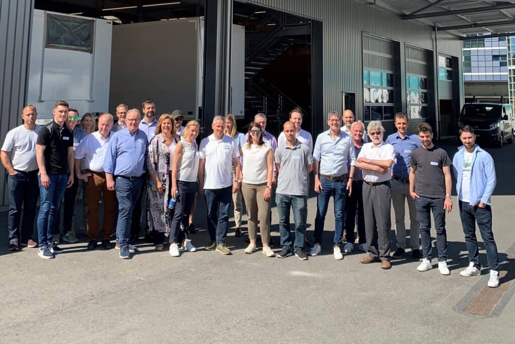 Team of professionals at SMA Moving company standing outside a modern logistics facility.