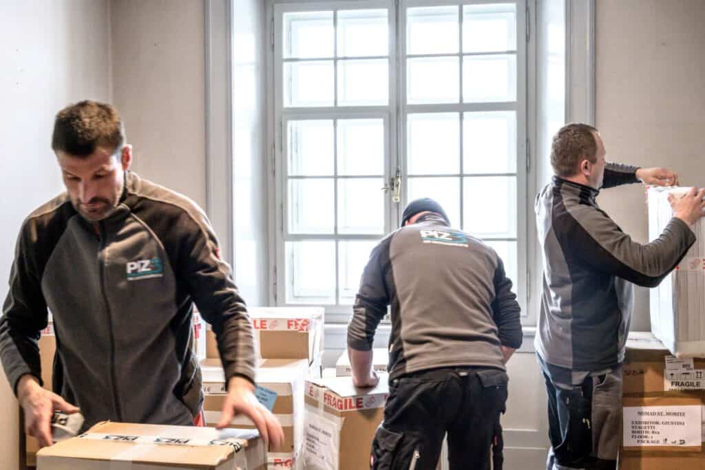 Moving team packing boxes in an office during a professional relocation.