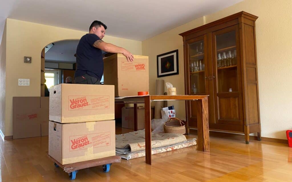 Moving boxes being unpacked in a home during relocation.