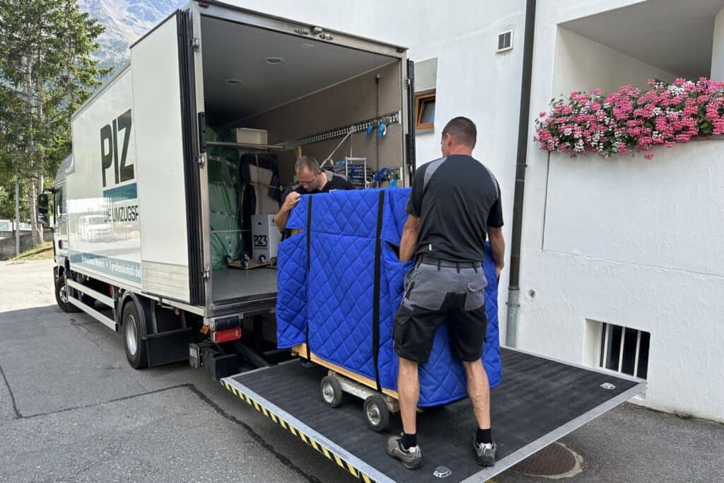 Professional moving team loading furniture onto moving truck for efficient relocation.